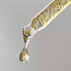 A close-up of a serum pipette with tiny bubbles