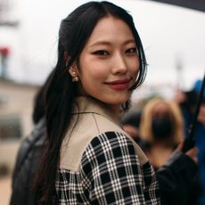 fashion week attendee wearing checked jacket