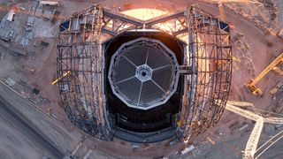 the construction site for a domed astronomical observatory is seen from above