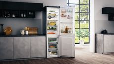 Hotpoint fridge freezer in kitchen with door open and food inside