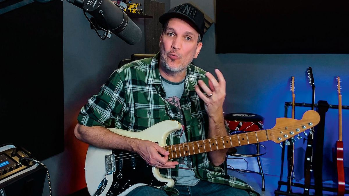 Guitar instructor holding a Fender Stratocaster