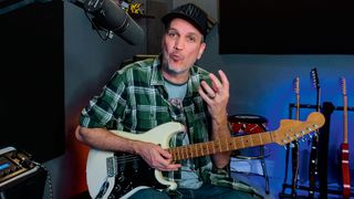 Guitar instructor holding a Fender Stratocaster