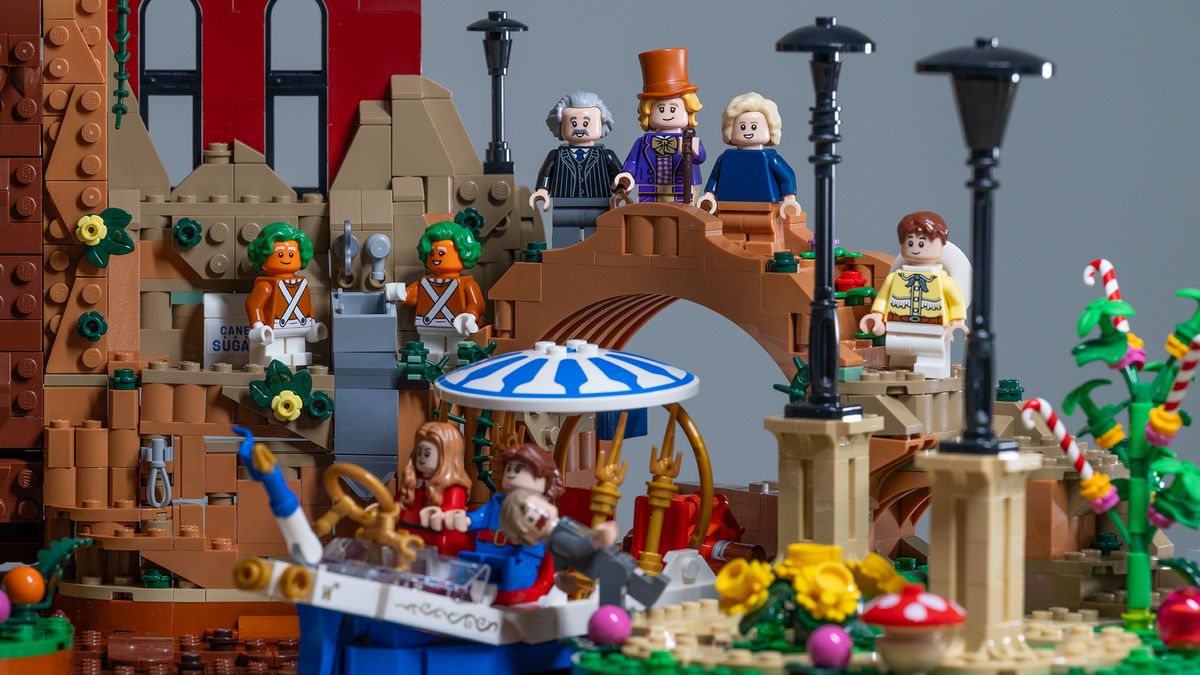 Lego Ideas Willy Wonka &amp; the Chocolate Factory (21360) set. Showing forced perspective with Wonkatania boat in the foreground and bridge with Grandpa Joe, Wonka, and Charlie in the background.