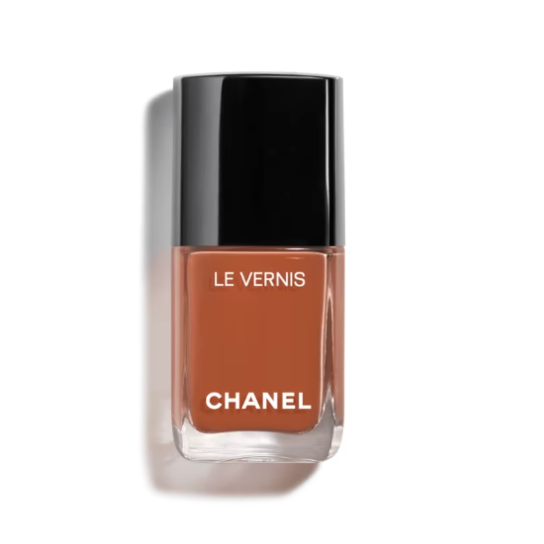 A product shot of the Chanel Le Vernis nail polish in shade 187 - SPIRITUELLE (a chestnut brown), on a white background