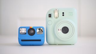 Polaroid Go Gen 2 side-by-side size comparison with an Instax Mini 12, against a white background