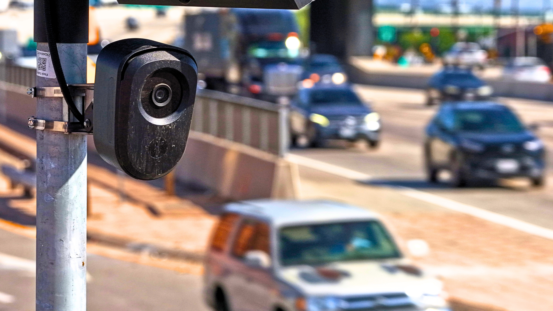a Flock camera with a street in the background