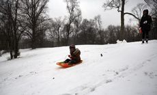 A child sleds in Prospect Park during a snow storm on Dec. 14. Much of the Northeast was hit by a storm stretching over 1,000 miles that could result in at least a foot of snow on parts of Ne