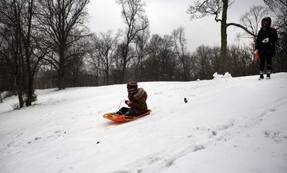 A child sleds in Prospect Park during a snow storm on Dec. 14. Much of the Northeast was hit by a storm stretching over 1,000 miles that could result in at least a foot of snow on parts of Ne