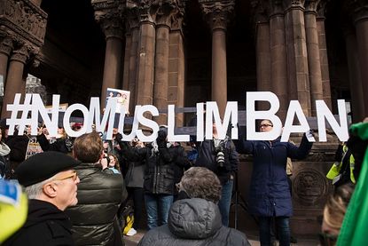 Protesters react to a ban on travel from certain majority-Muslim countries.