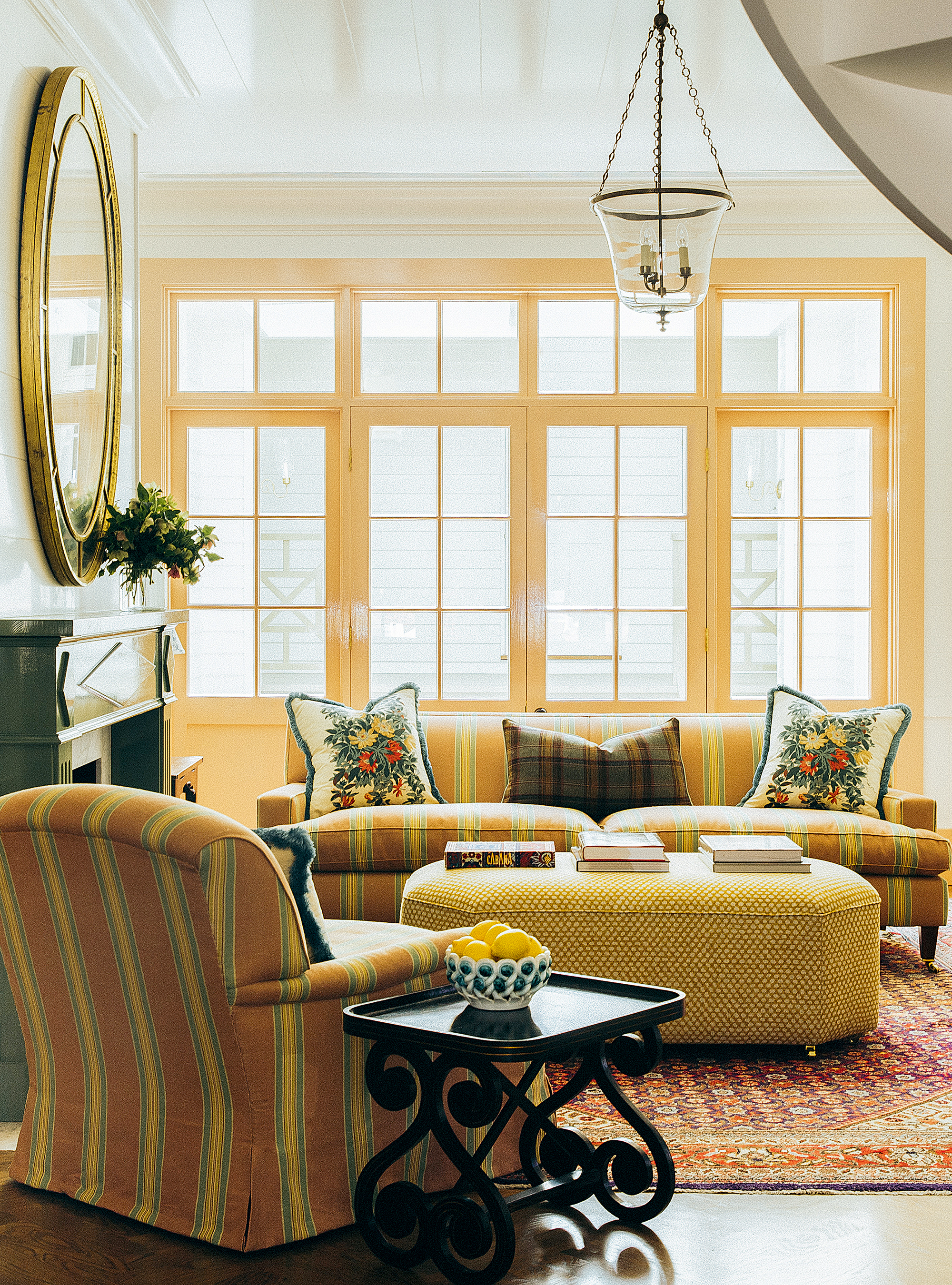 Living room with yellow sofa, and yellow painted window frames