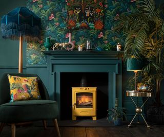 yellow log burner in teal living room with botanical wallpaper