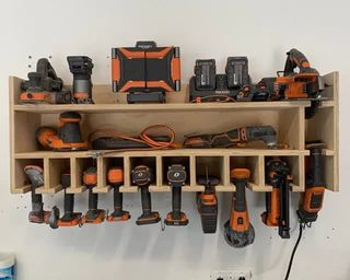 a custom wooden shelving unit full of power tools