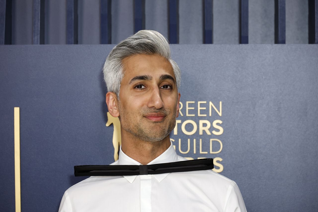 Headshot of Tan France wearing a white shirt, looking at the camera.