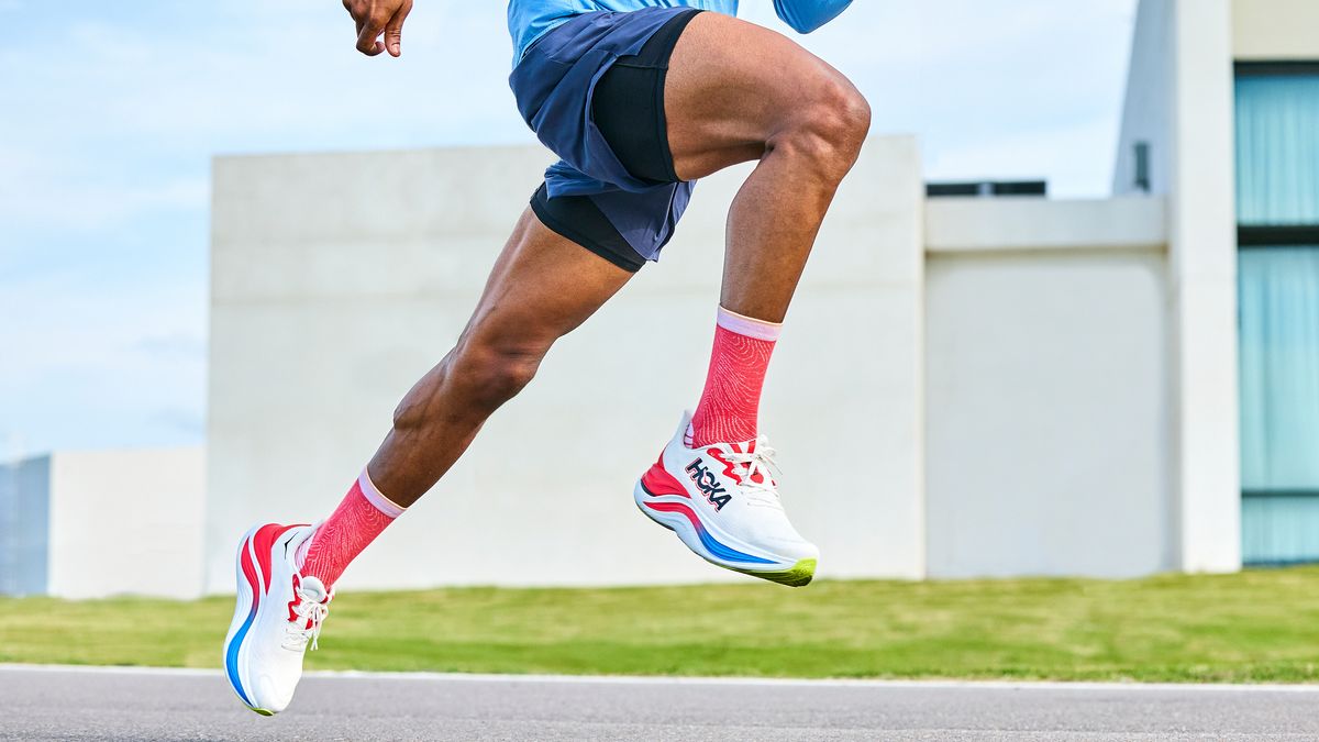 the bottom half of a male running in the Hoka Skyward X running shoe