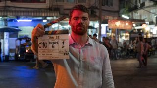 The Night Agent season 2 star Gabriel Basso with a clapperboard in behind the scenes shot