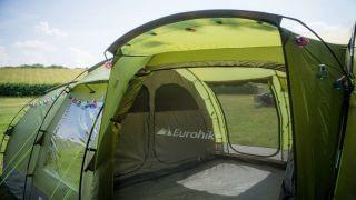 A green Eurohike tent pitched up in the countryside