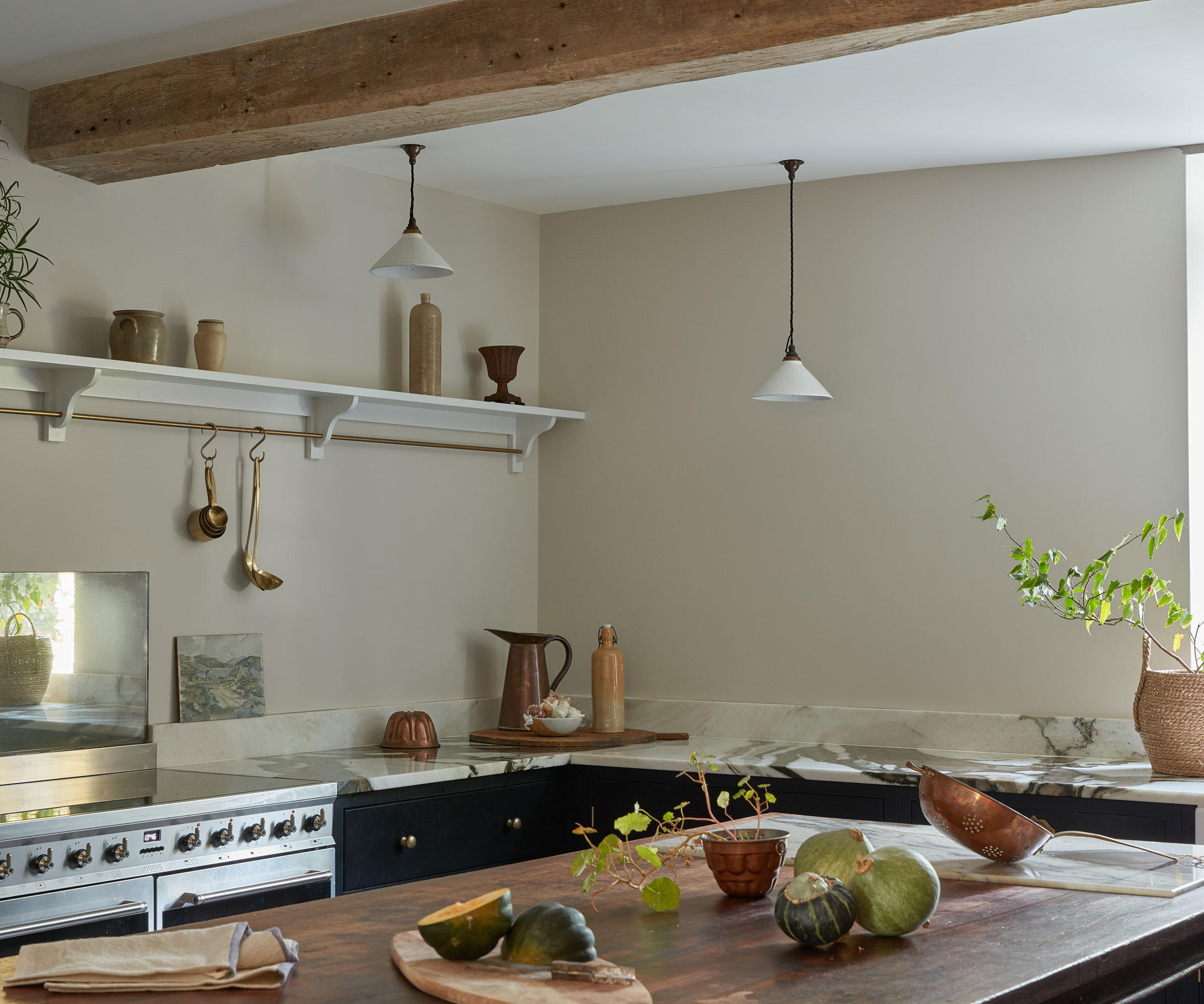 neutral rustic kitchen with marble worktops and wooden topped island