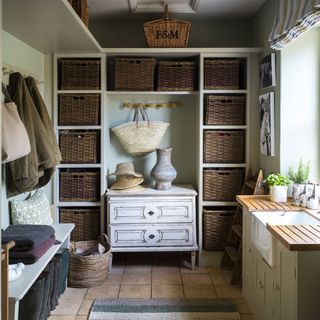 boot room terracotta stone flooring and wicker baskets