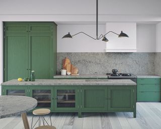 Kitchen lighting ideas in a green kitchen with quartz worktop.