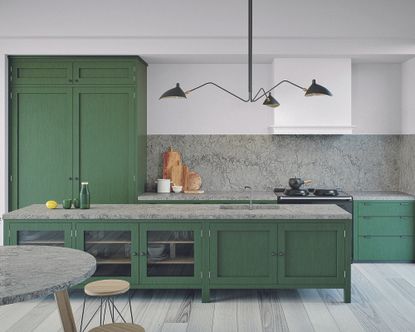 How to plan kitchen lighting with a statement pendant light over green kitchen cabinetry.