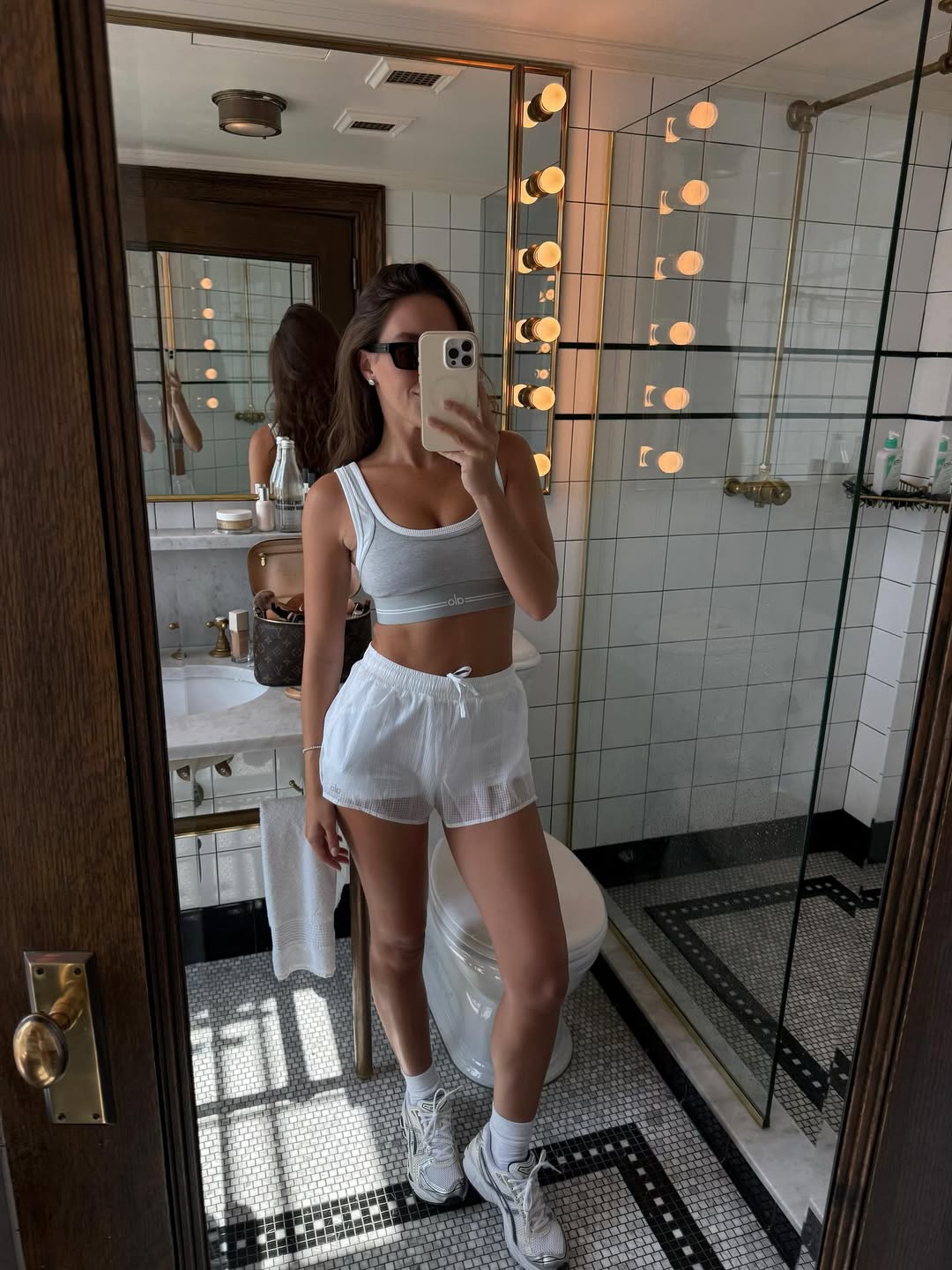 Woman wearing a workout set and sneakers.