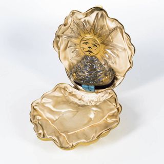 Golden clamshell perfume case