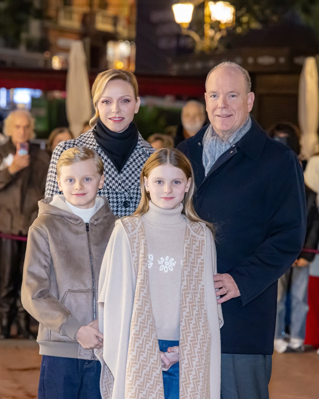 Princess Charlene, Prince Albert, Prince Jacques and Princess Gabriella posing at a Christmas event