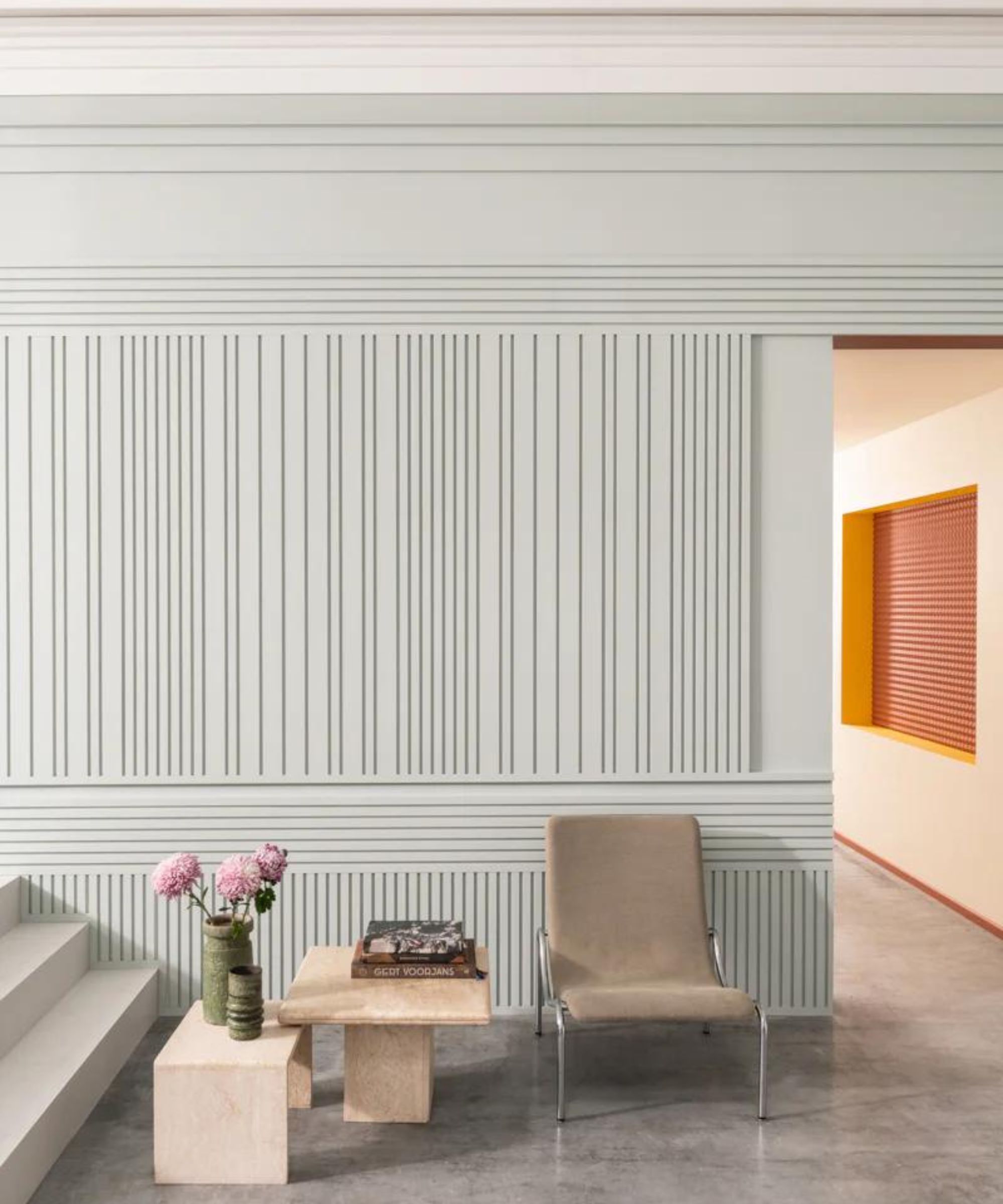 A hallway with light blue slatted wall panelling in more vertical and horizontal directions