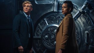 Army Of Thieves Matthias Schweighöfer and Nathalie Emmanuel stand in front of an ornate vault door