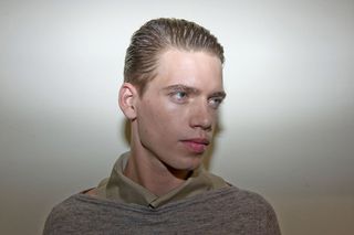 male model with slicked back styled hair looking to the right