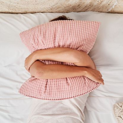 4-7-8 sleep method: A woman with a pillow over her face