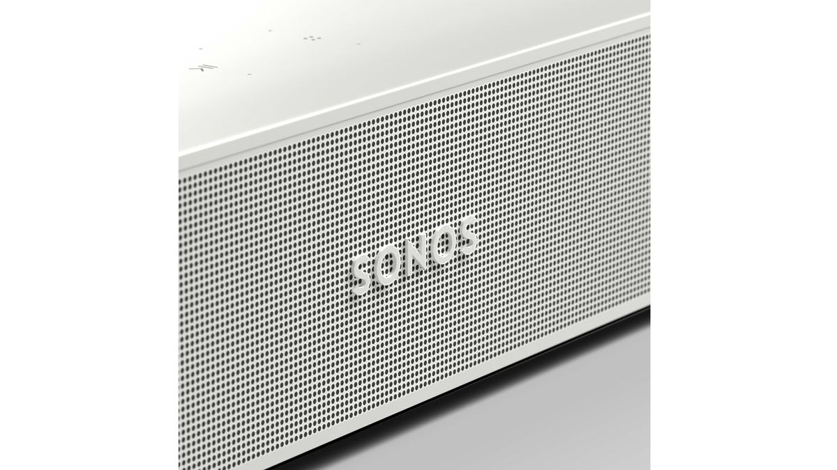 A close-up of a white Sonos Beam Gen 2, with the 'Sonos' logo in the middle of the grille