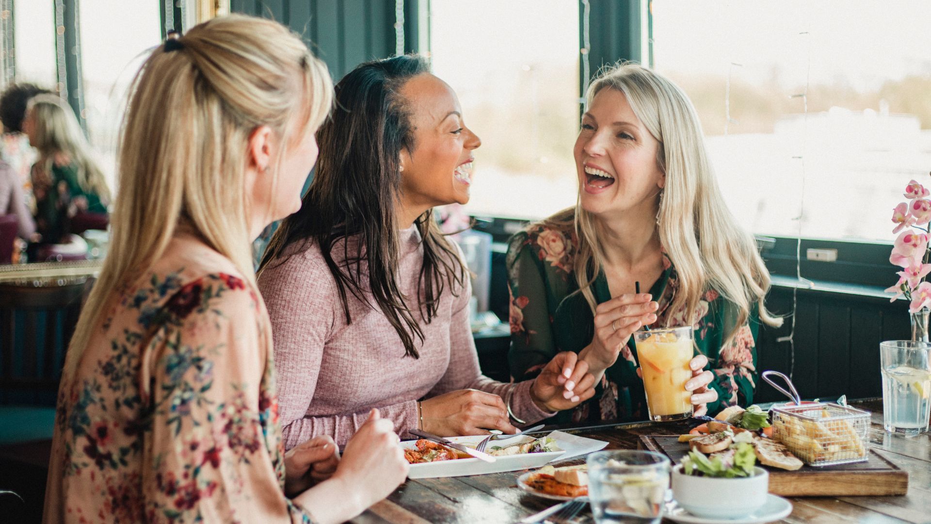 What is the key to happiness in later life - women sat around the table eating and laughing together