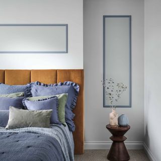 Blue bedrom with brown headboard