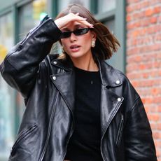 Hailey Bieber wearing sunglasses and leather jacket