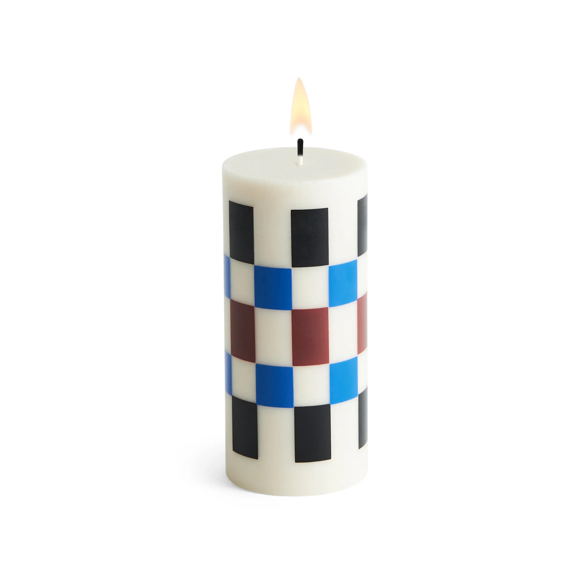 white candle with checkered print in black, blue and red