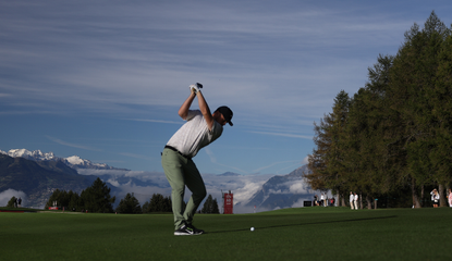 A golfer hits a shot at Crans-sur-Sierre Golf Club