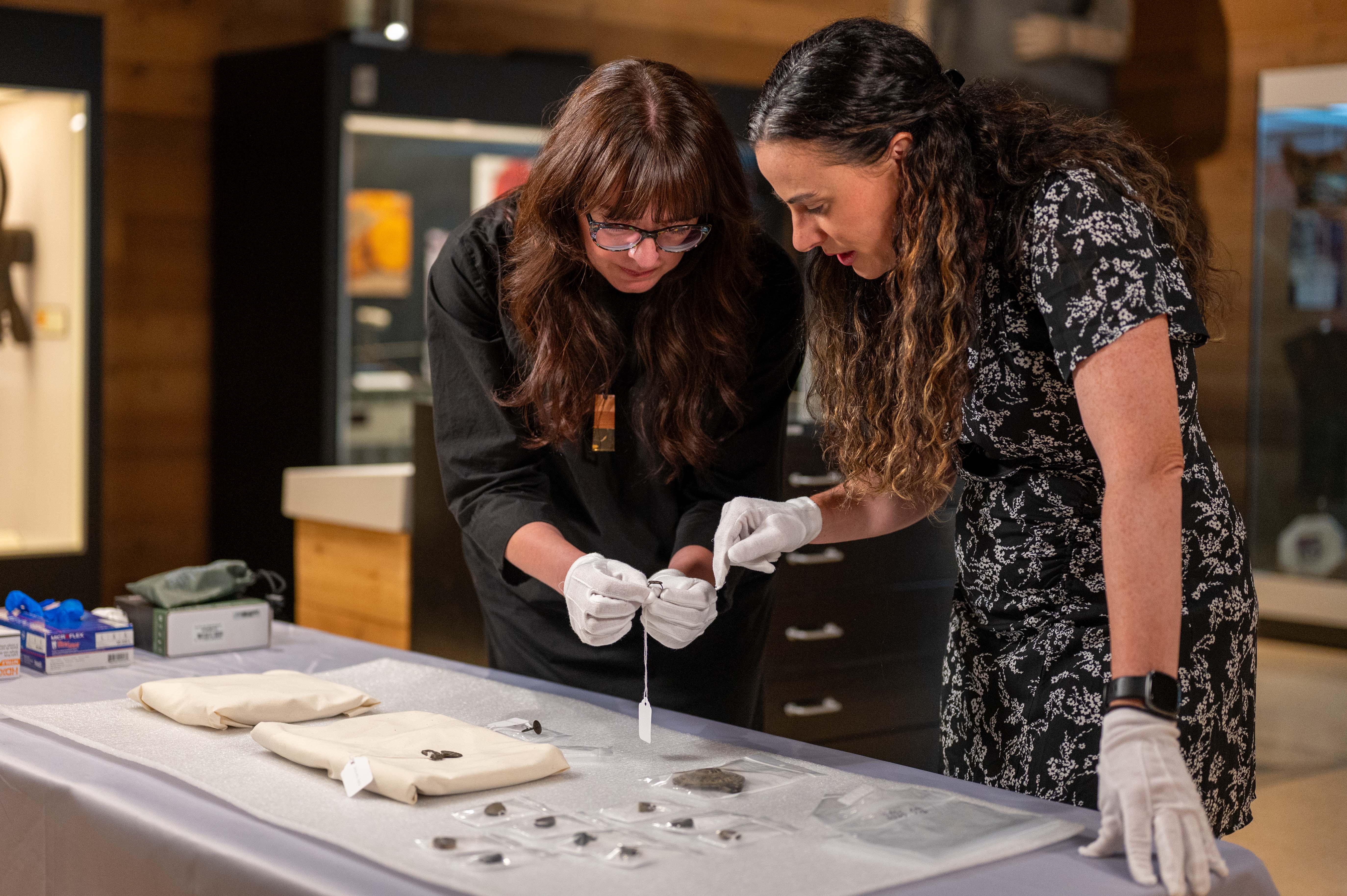 Sabrina Higgins, SFU associate professor, Global Humanities and Archaeology, and Barbara Hilden, director, SFU Museum of Archaeology and Ethnology, examine the rare artifacts that have been donated to SFU for study