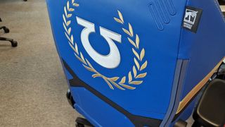 Secretlab Warhammer 40,000 chair seen from behind, with an Ultramarines symbol against a field of blue