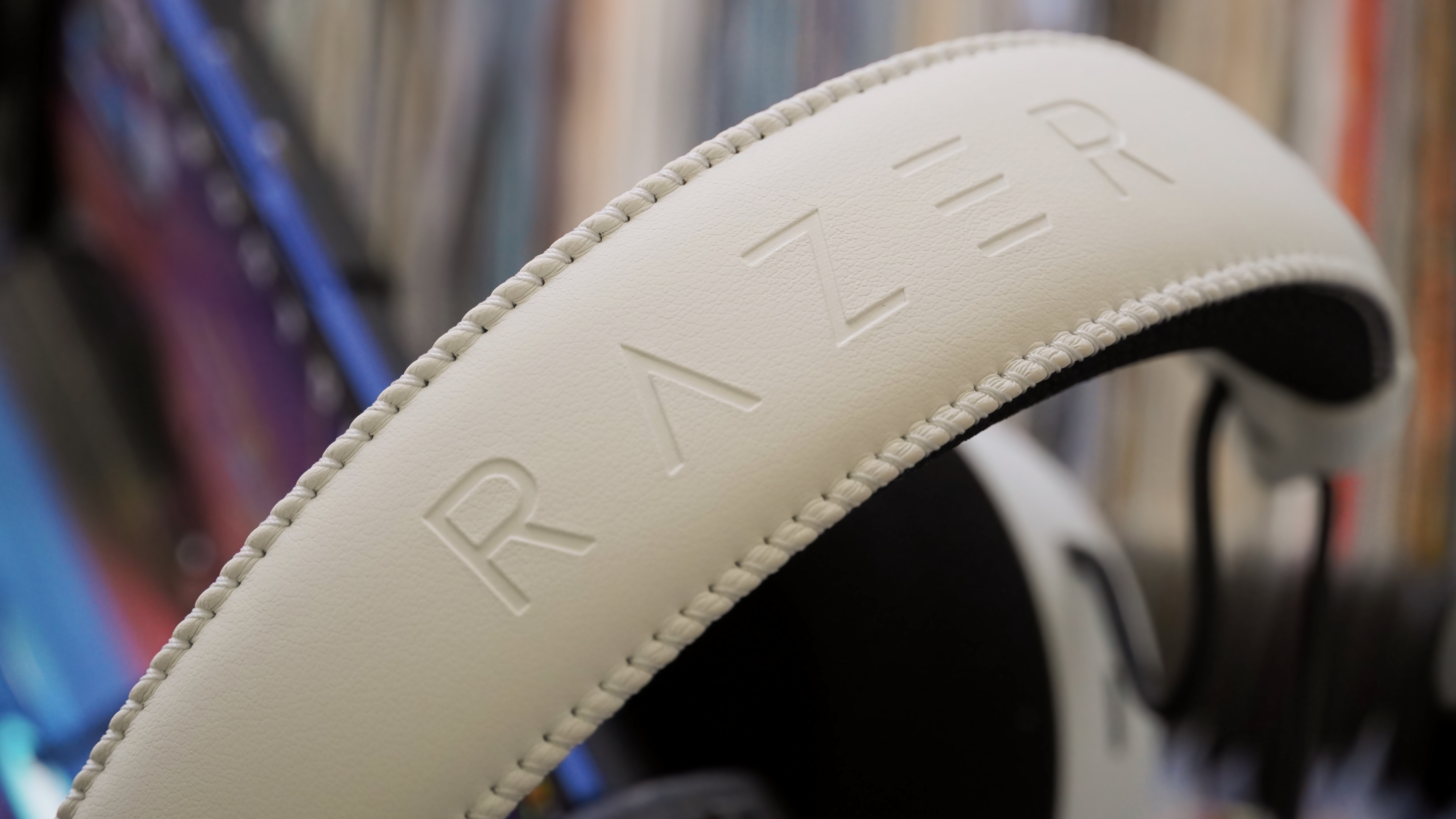 The Razer BlackShark V3 Pro gaming headset laid atop records showing the leather headband.