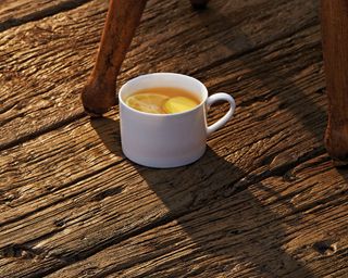 mug sitting on a deck made from Millboard Weathered Oak Vintage