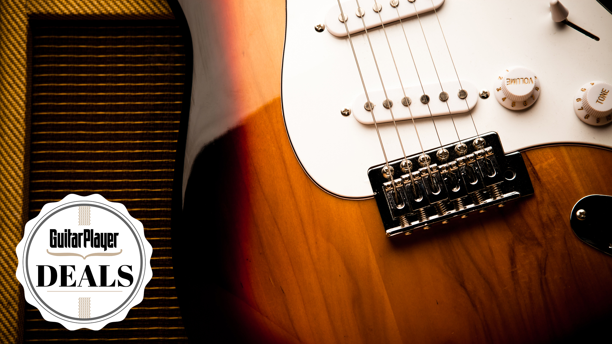 Close up on a Stratocaster sat against a guitar amp