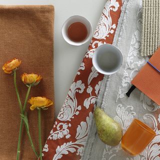 orange flower with teacups and orange coloured glass