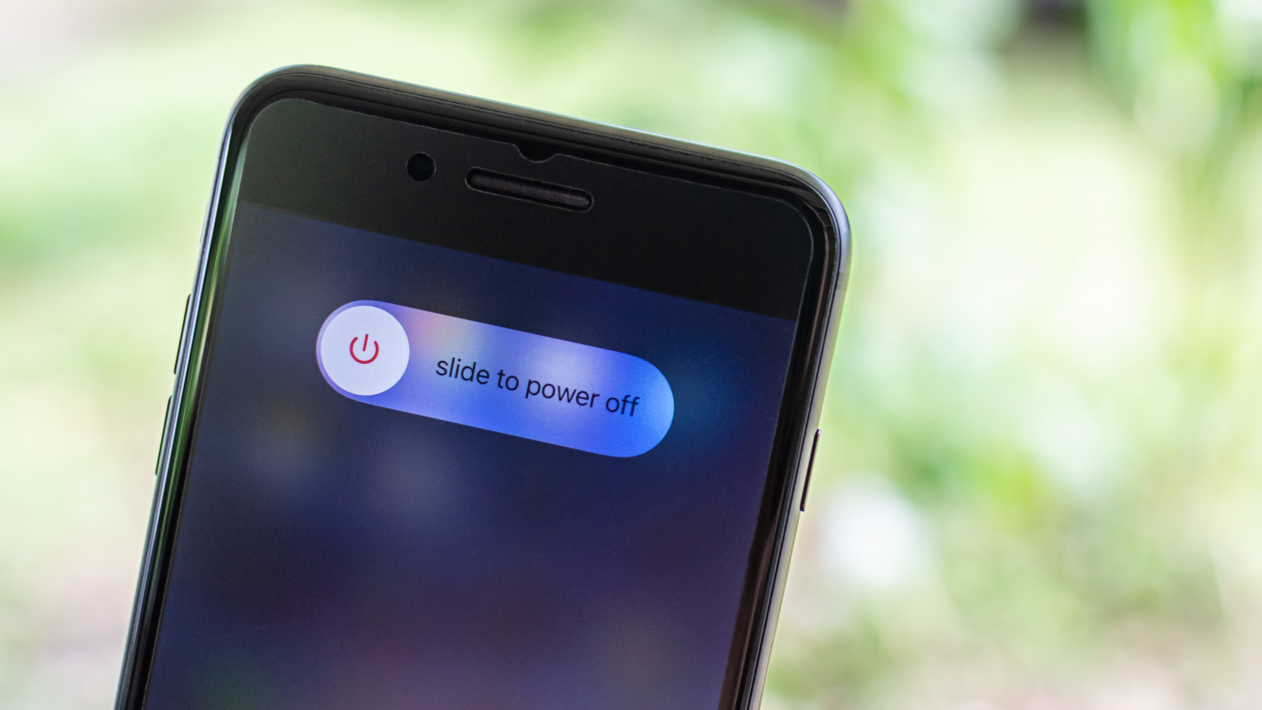 An iPhone showing a 'slide to power off' symbol