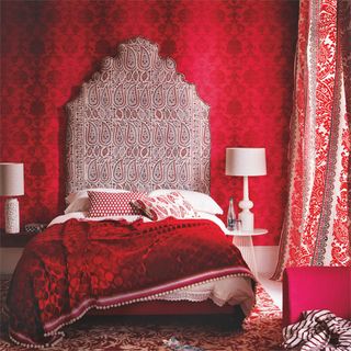 bedroom with printed red curtains