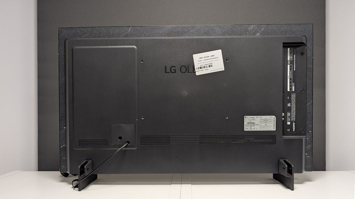 The back of the LG C5 42-inch OLED TV straight-on on a TV cabinet.