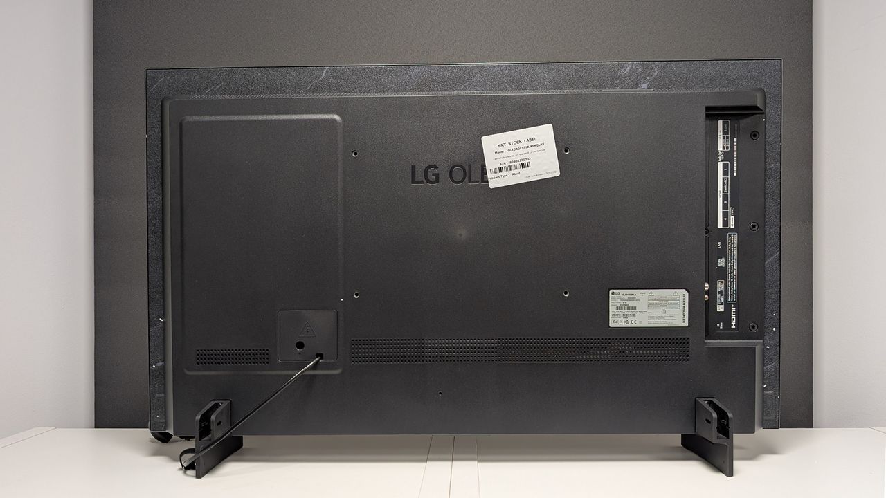 The back of the LG C5 42-inch OLED TV straight-on on a TV cabinet.
