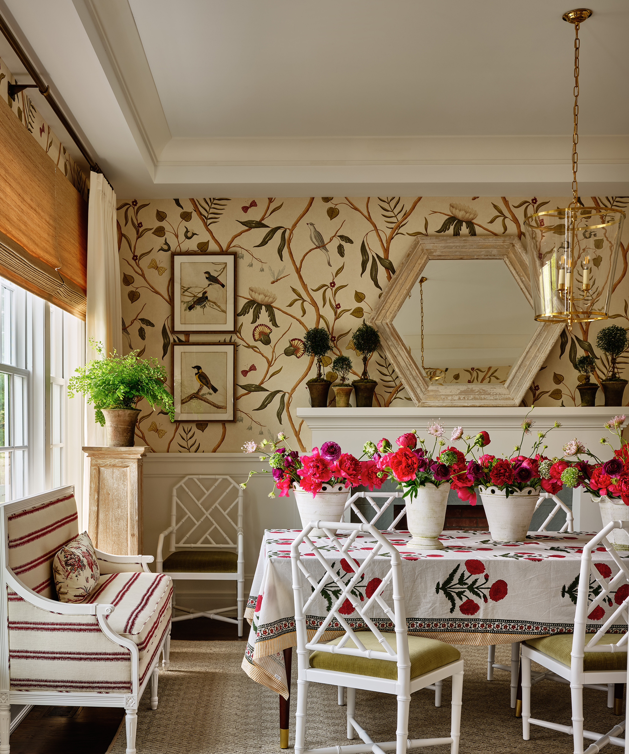 dining room with patterned wallpaper and floral tablecloth on the table