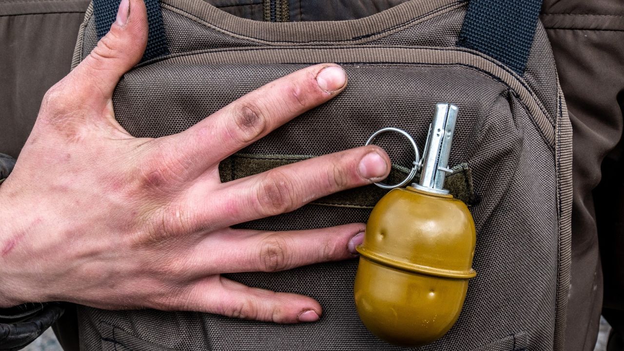 A Ukrainian soldier pcitured with a grenade, Lysychansk, 10 May 2022