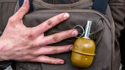 A Ukrainian soldier pcitured with a grenade, Lysychansk, 10 May 2022